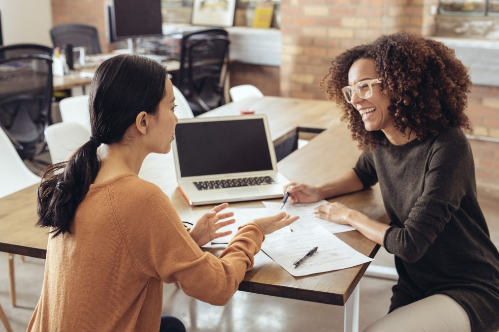 a woman talks with her female agent in an office