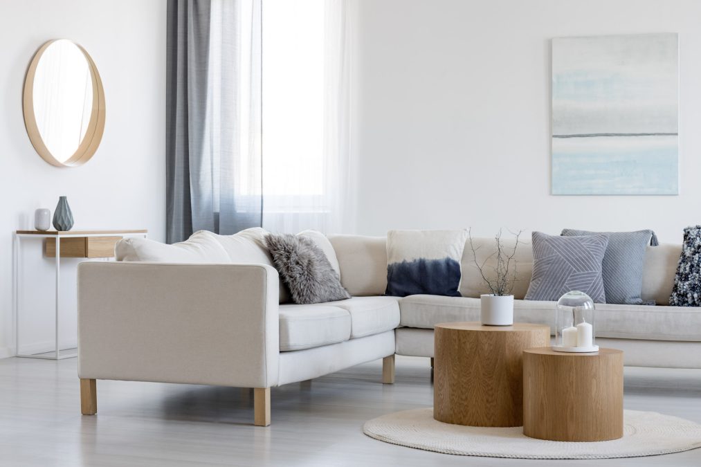 A modern living room with a cream L-shaped sofa