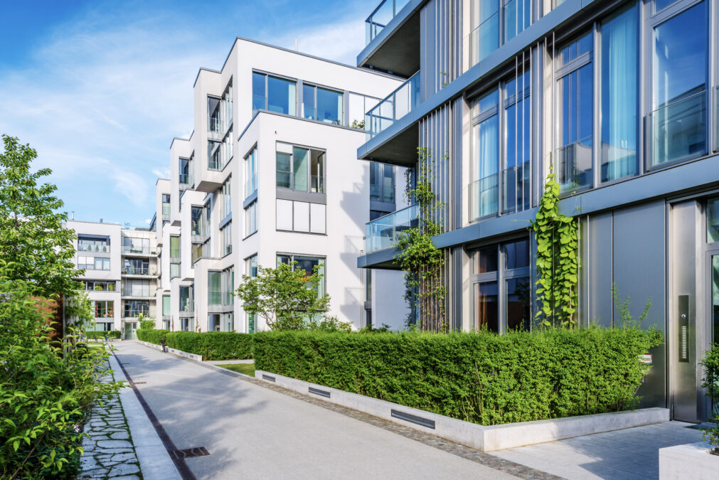 Exterior of low rise condominium buildings with landscaped walkway