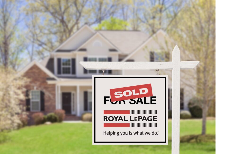 Royal LePage sold sign in front of a house on a sunny day