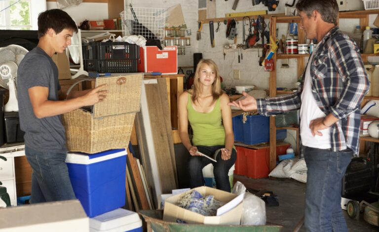 Dad with teenage daughter and son organizing boxes in the garage