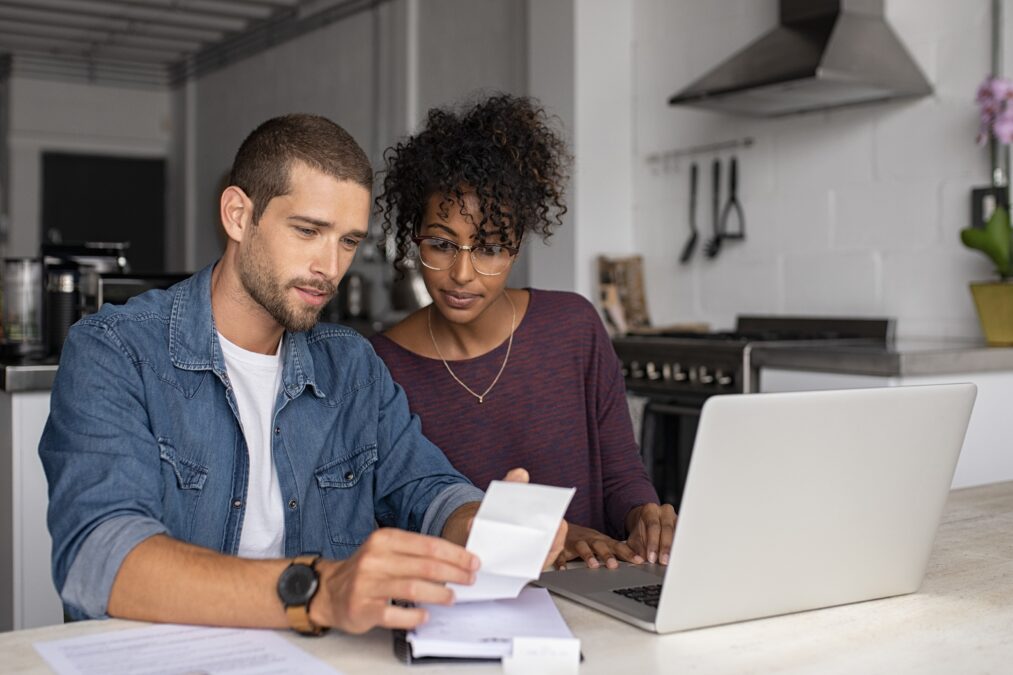 Young multiethnic couple examining home finance