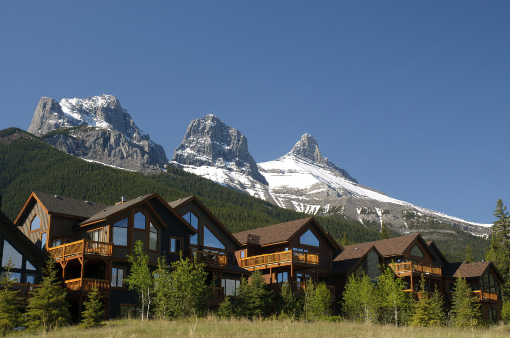 Row of rooftops in Canmore, Alberta, with view of the Three Sisters mountains in the background