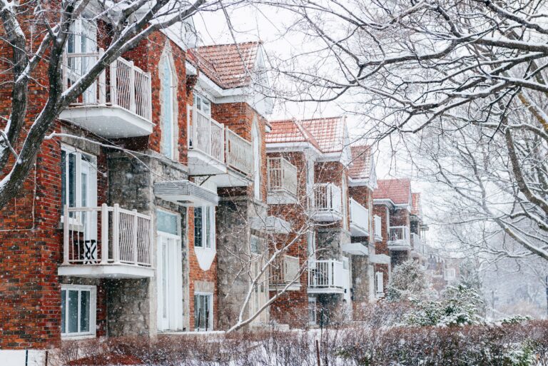Exterior shot of colourful row homes in winter