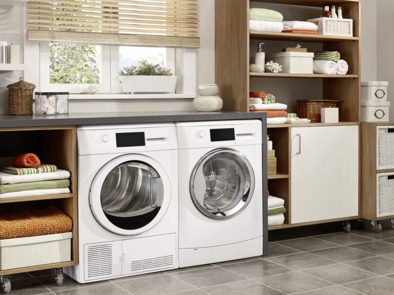 Modern, organized laundry room with white washer and dryer