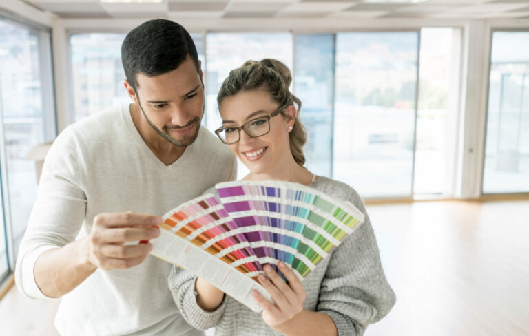 Young couple looking through a selection of paint chips