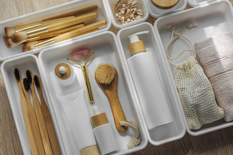 Cosmetics products arranged in white organizers.