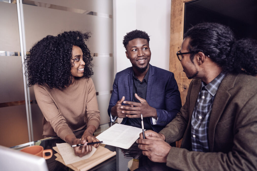 Young couple talking with their real estate agent