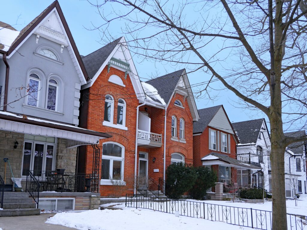 Residential street in Toronto with older semi-detached houses with gables