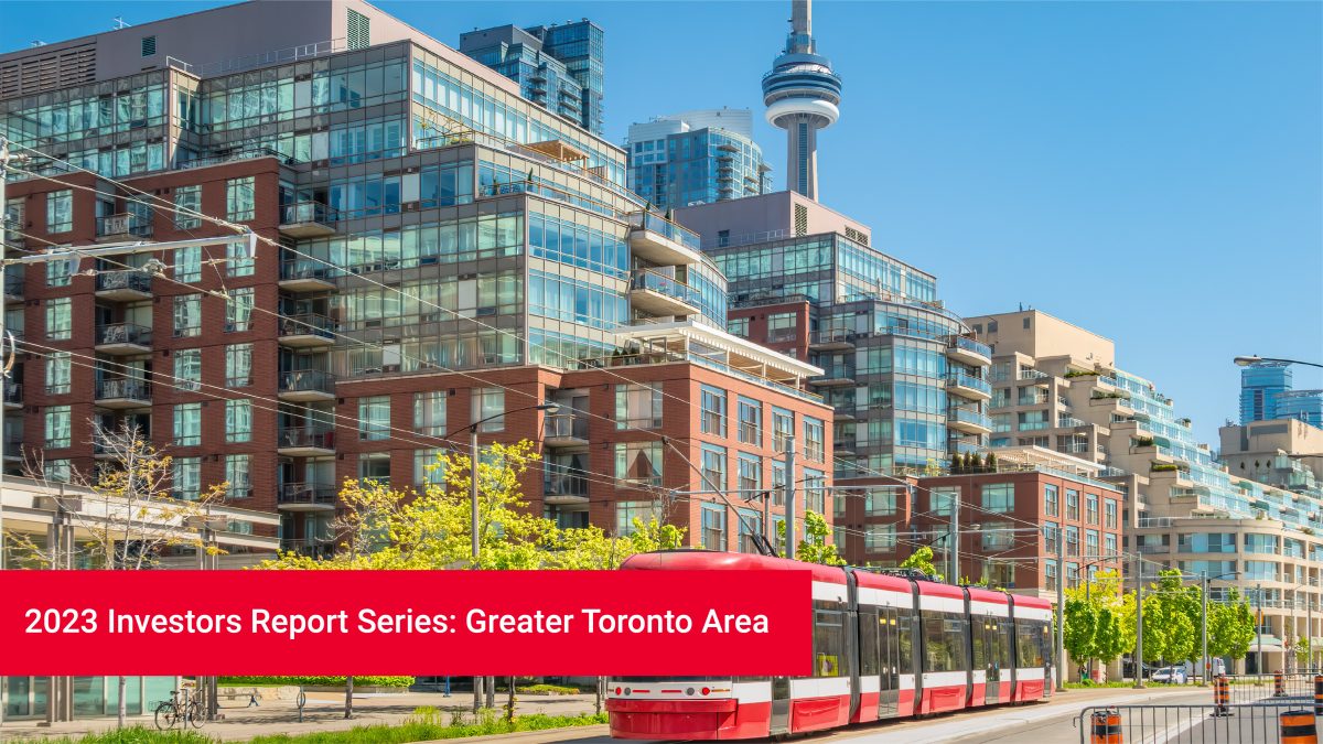 A Toronto streetcar rolls by a series of condo buildings and the CN tower