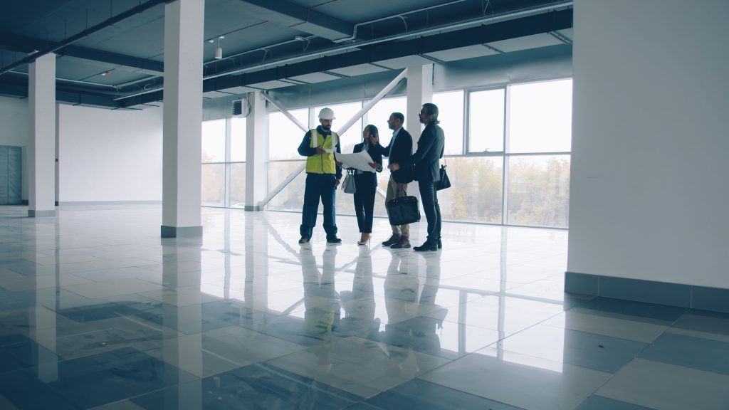 A group of professionals conducting an indoor inspection in a commercial building