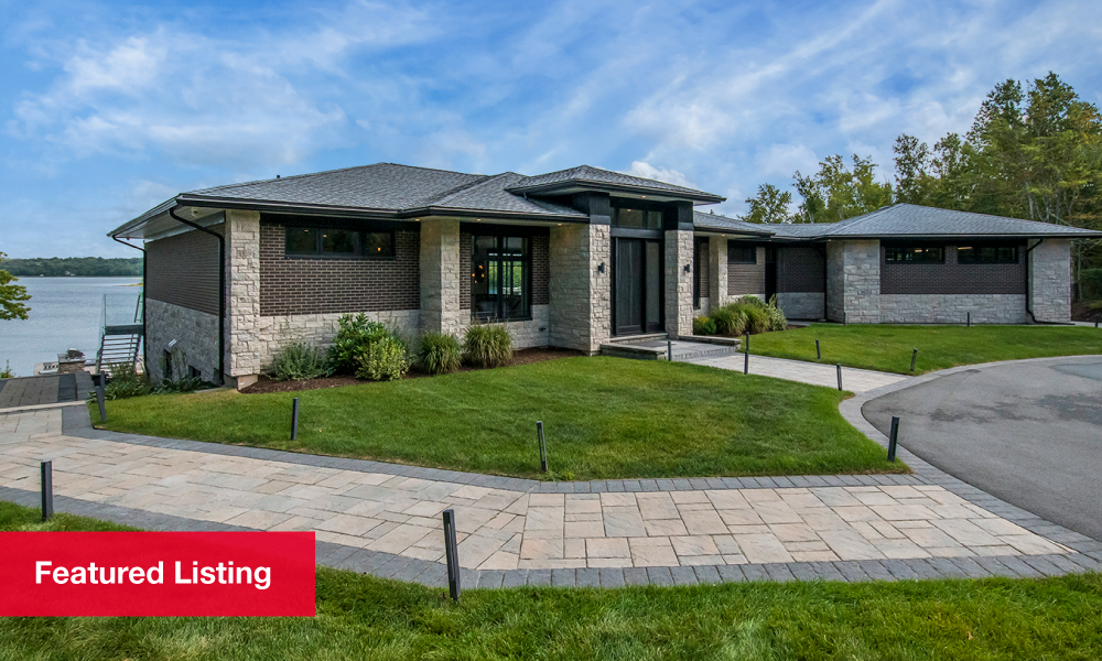 Grey one-storey home with modern landscaping during the day