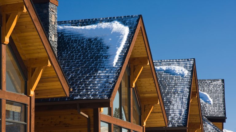 Snow-covered roofs of ski chalets during the day