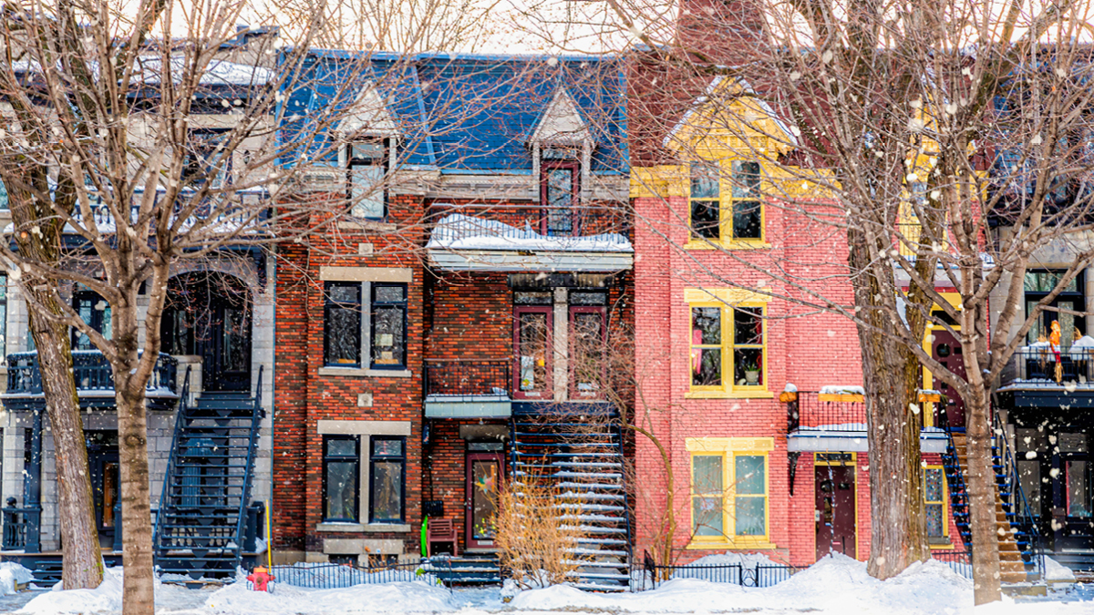 Winter street in Montreal, with traditional style architecture, snow-covered balconies and heavy snowfall