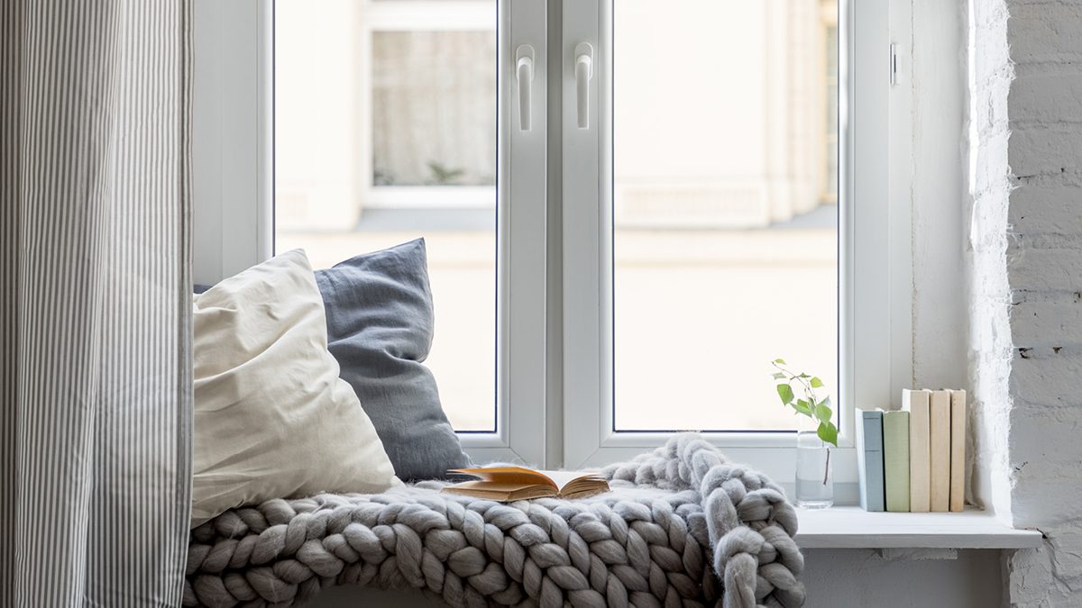 Home interior with cozy leisure area beside window
