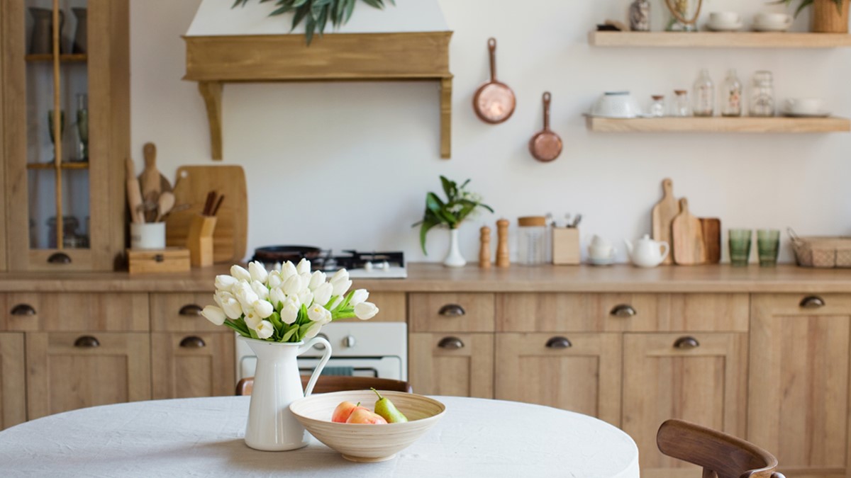 A vase of white tulips on a round kitchen table