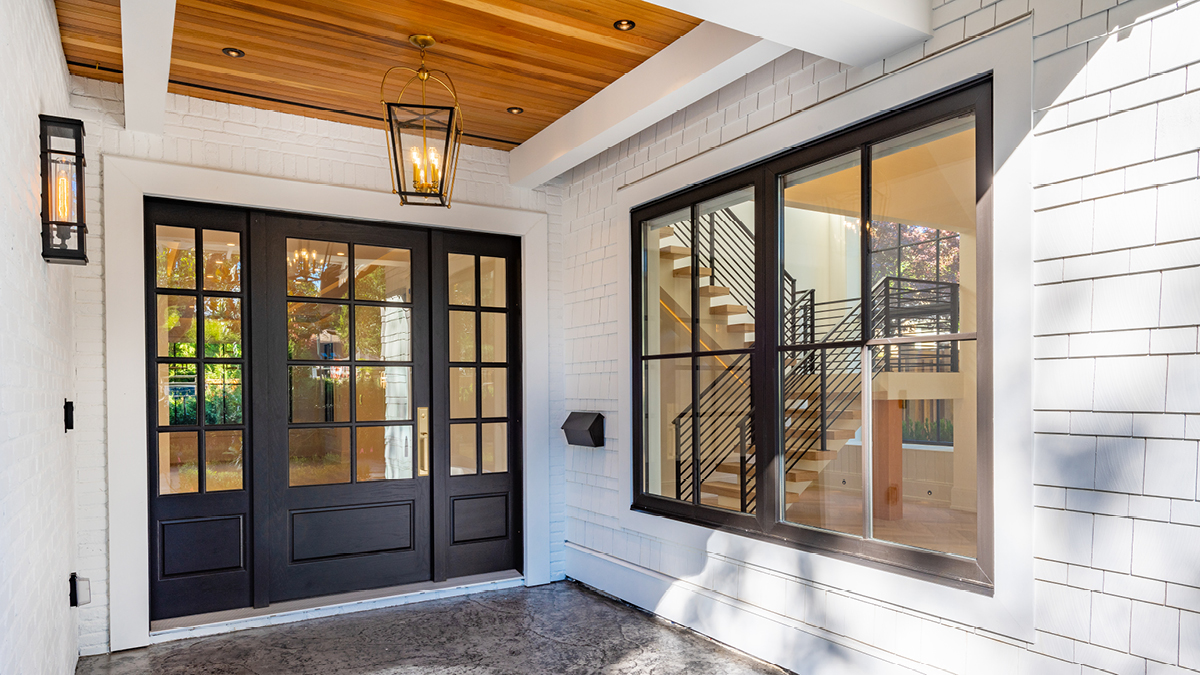 Black-framed front door and window of modern home, exterior