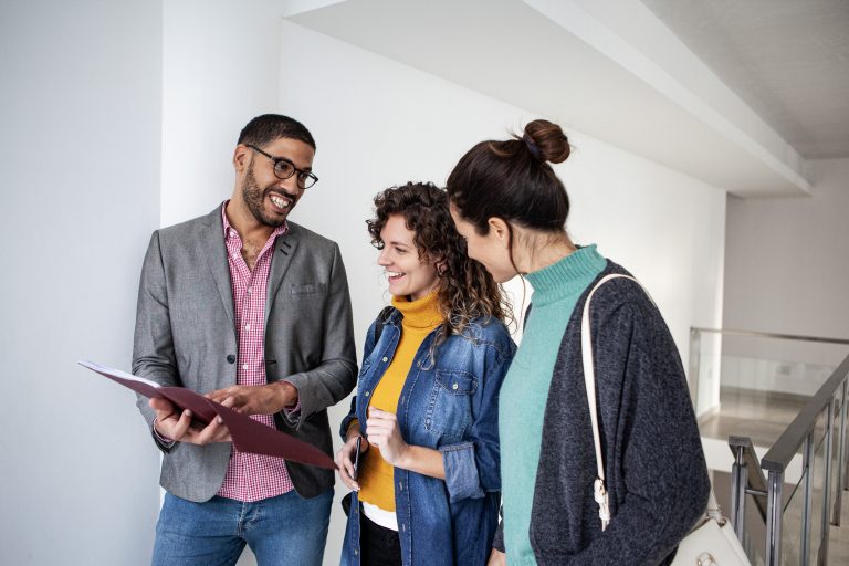 Women viewing vacant apartment with real estate agent