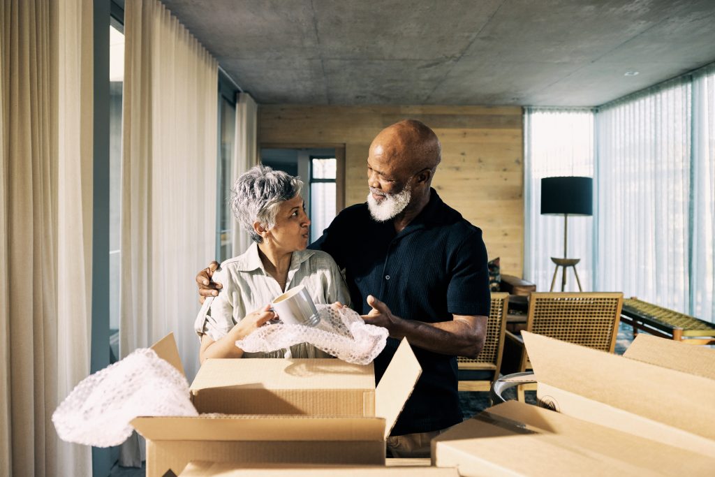 Couple unpacking boxes during move