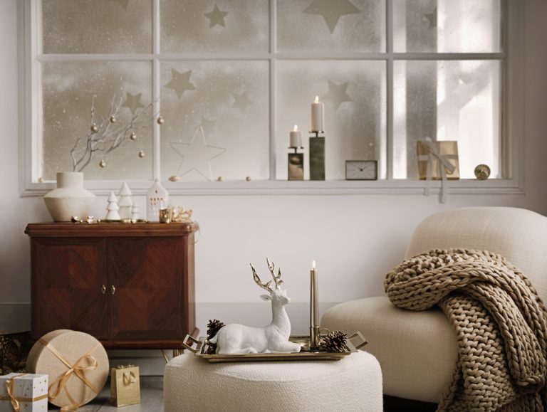 Cozy and stylish christmas living room interior with design armchair, decoration and accessories