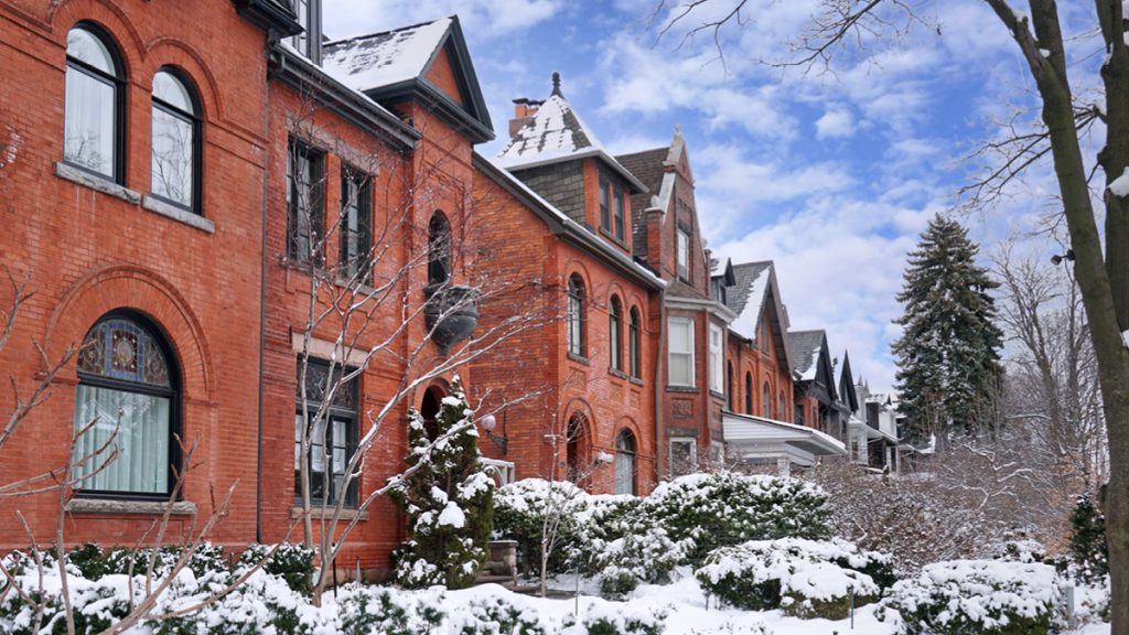 Red brick townhouses in the snow during the day