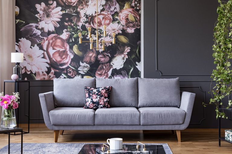 Floral wallpaper in a modern living room with a grey sofa