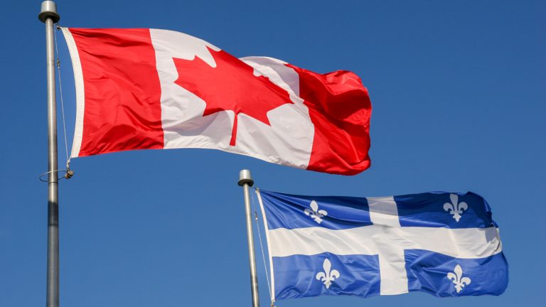 The Canadian and Quebec flag side by side