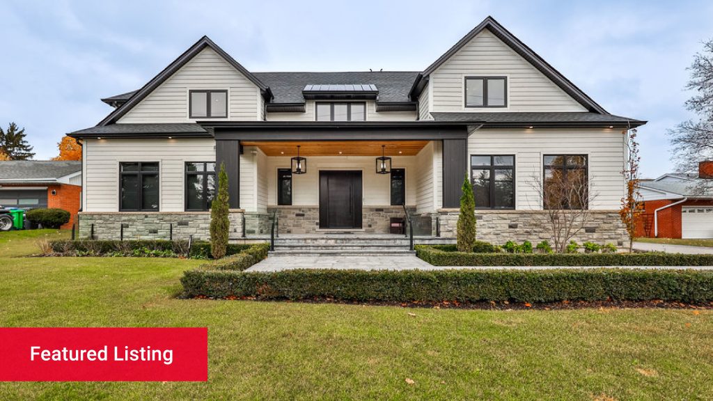 A modern white home with an A-line roof in a suburban neighbourhood