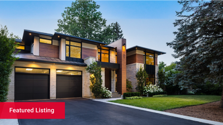 Exterior view of front of modern luxury home at night