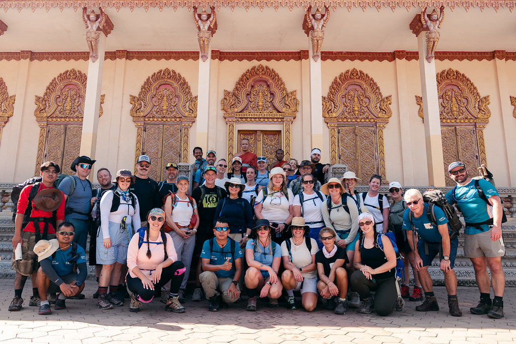 A group of hikers posing in front of a temple in Cambodia