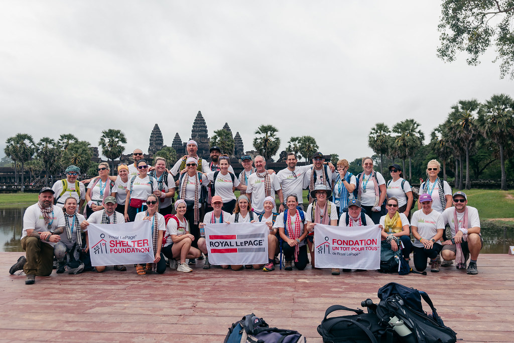 A group of hikers pose for a photo in front of Angkor Wat in Cambodia