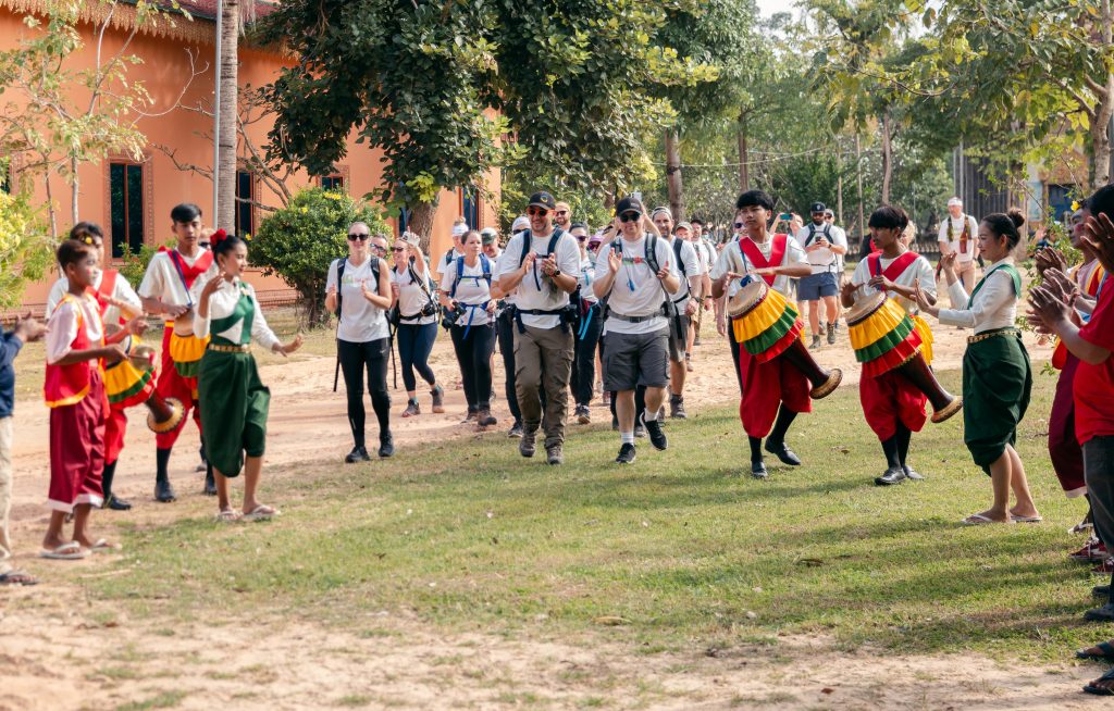 Cambodian dancers and musicians play for a group of hikers