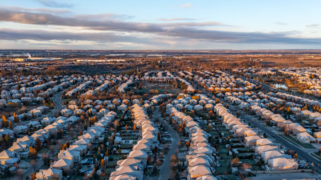 An aerial view of an Ontario subdivision of detached homes covered in snow