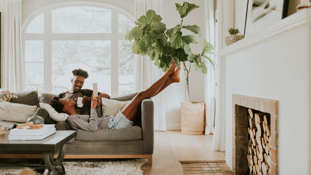 A couple relax on the living room sofa together