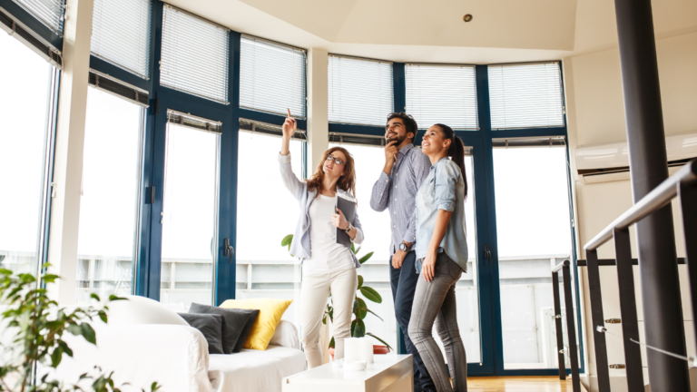 A young couple viewing home with female realtor