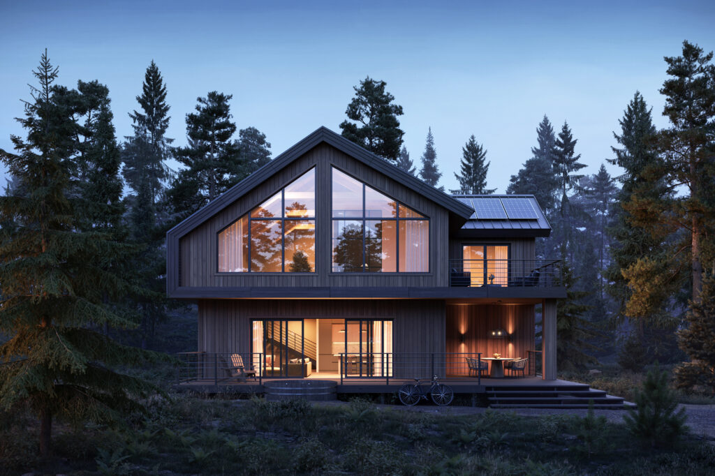 House with large windows and surrounded by trees during night