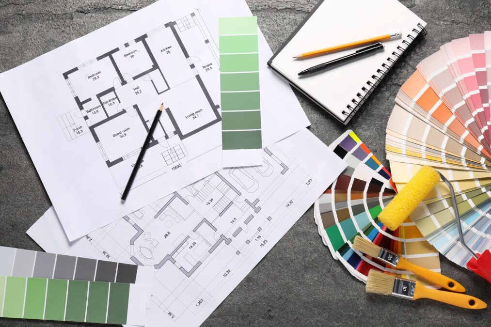 House plans and different decorator's tools on grey table, flat lay stock photo