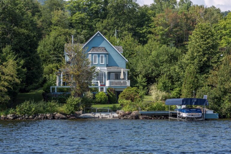 A blue waterfront cottage overlooking the lake
