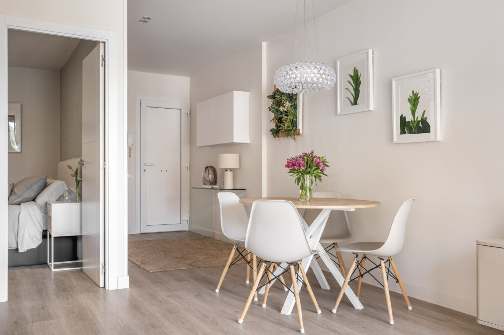 Modern condo dining area next to bedroom and front entry