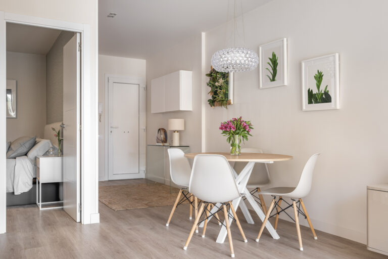 Modern condo dining area next to bedroom and front entry
