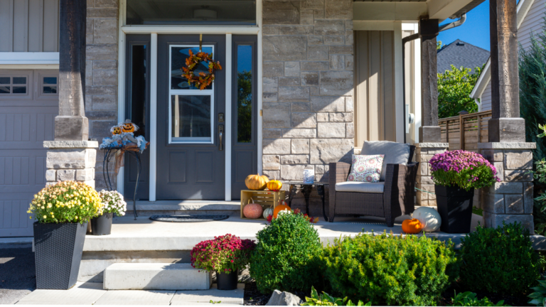 Colourful pumpkins, gourds and mums create a luxury autumn halloween and thanksgiving landscaping decor